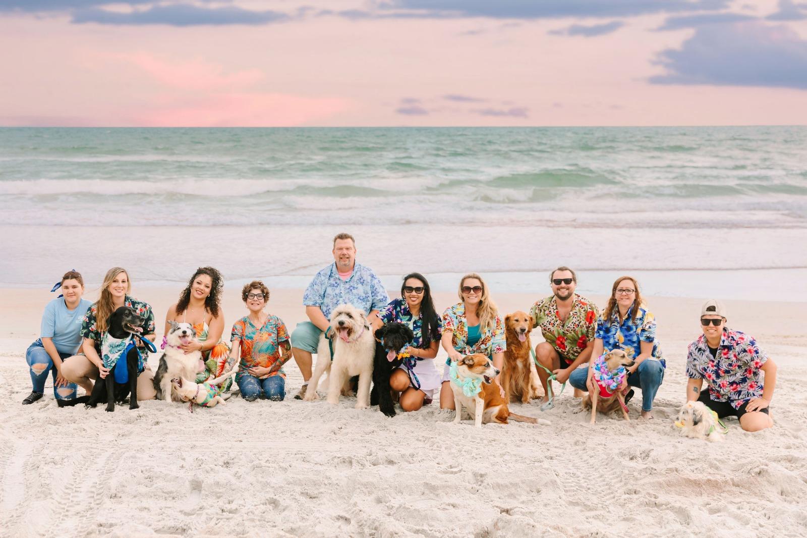 The Salty Dog Vacations team with their dogs on the beach